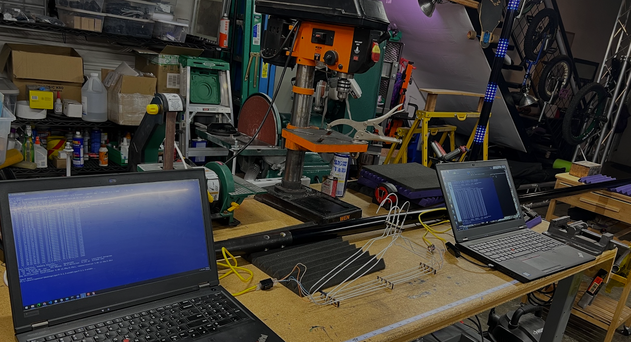 Two ThinkPads on the bench joined by a transmission line made of four wire coat hangers